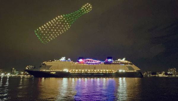 A Champagne bottle made of drones forms above the Disney Treasure. A Champagne bottle made of drones forms above the Disney Treasure.