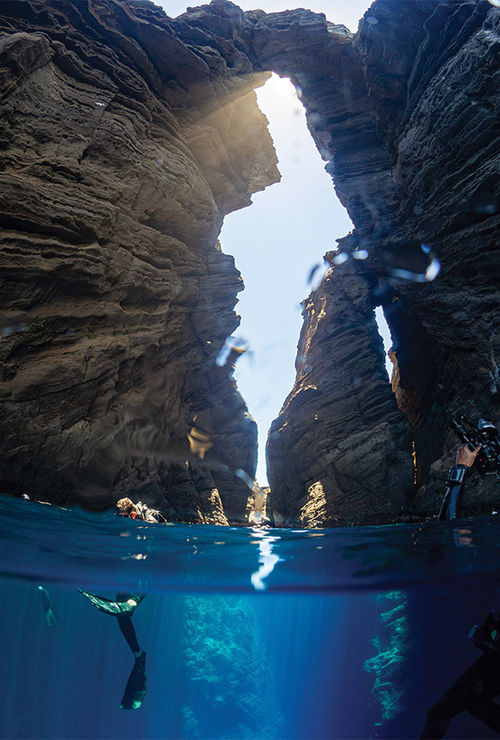 Divers in the "keyhole" rock formation on Lehua, a moon-shaped islet a half-mile off Niihau. Divers in the "keyhole" rock formation on Lehua, a moon-shaped islet a half-mile off Niihau.