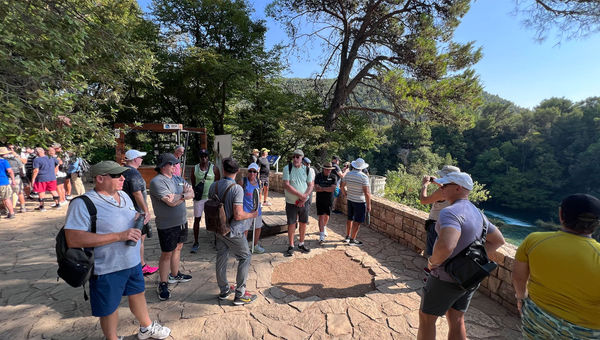 Guests listen to a guide during an excursion to Krka National Park in Croatia. Guests listen to a guide during an excursion to Krka National Park in Croatia.
