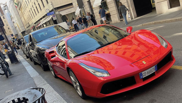 High-end sports cars on Via Montenapoleone in Milan's Golden Quad, home to the flagship stores of world-renowned designers. High-end sports cars on Via Montenapoleone in Milan's Golden Quad, home to the flagship stores of world-renowned designers.