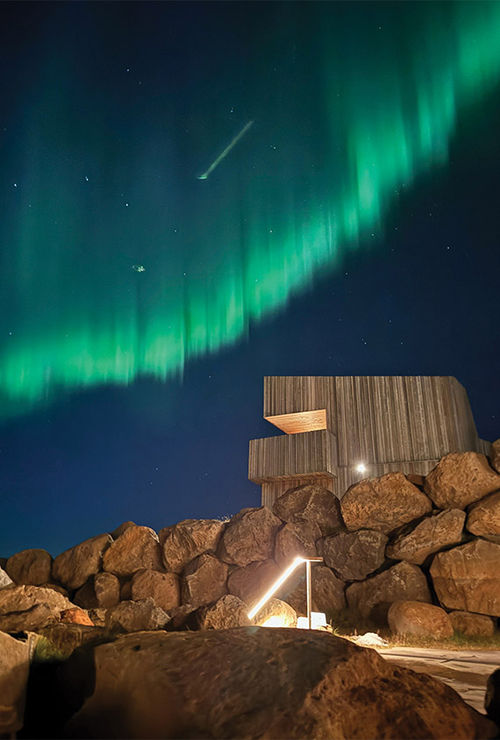 The northern lights dance over the new Highland Base hotel in Iceland, as seen from its geothermal baths. The northern lights dance over the new Highland Base hotel in Iceland, as seen from its geothermal baths.